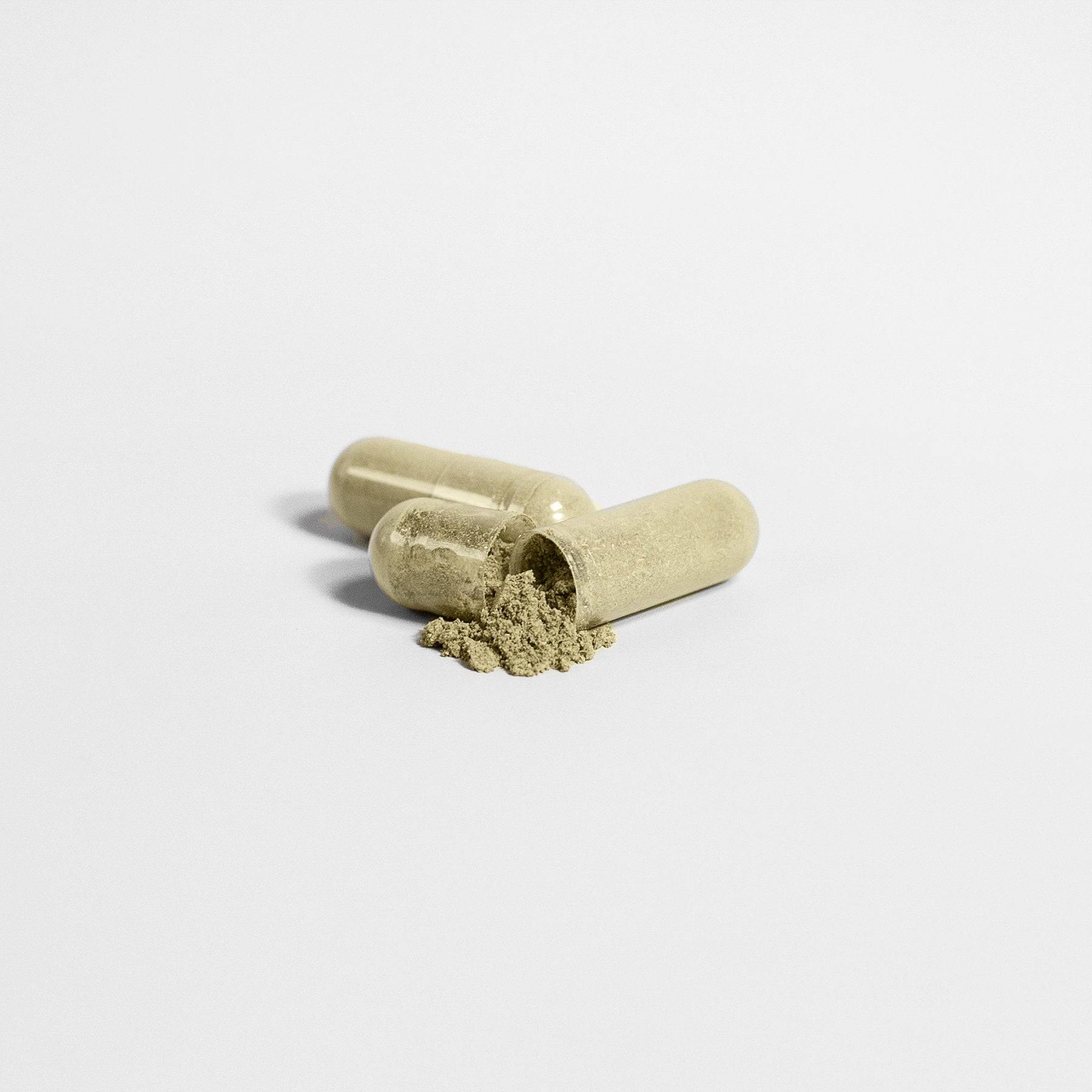 Close-up of Hair, Skin, and Nails Essentials capsules with herbal powder spilling out, emphasizing natural ingredients for beauty support.